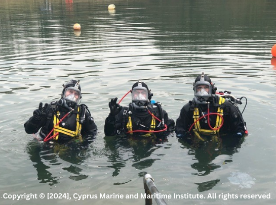 Three scuba divers on the surface of the water