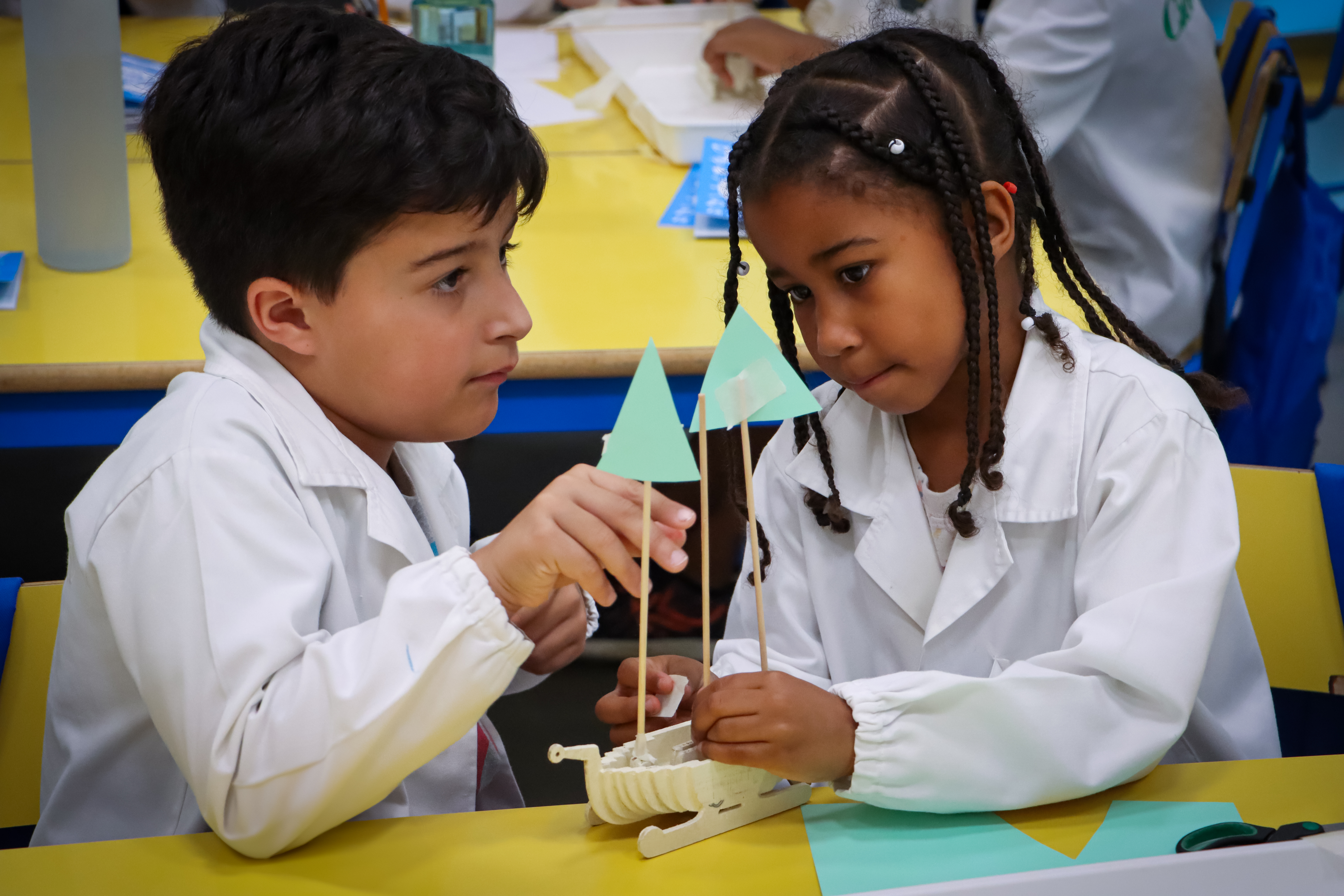 Two students building a small boat