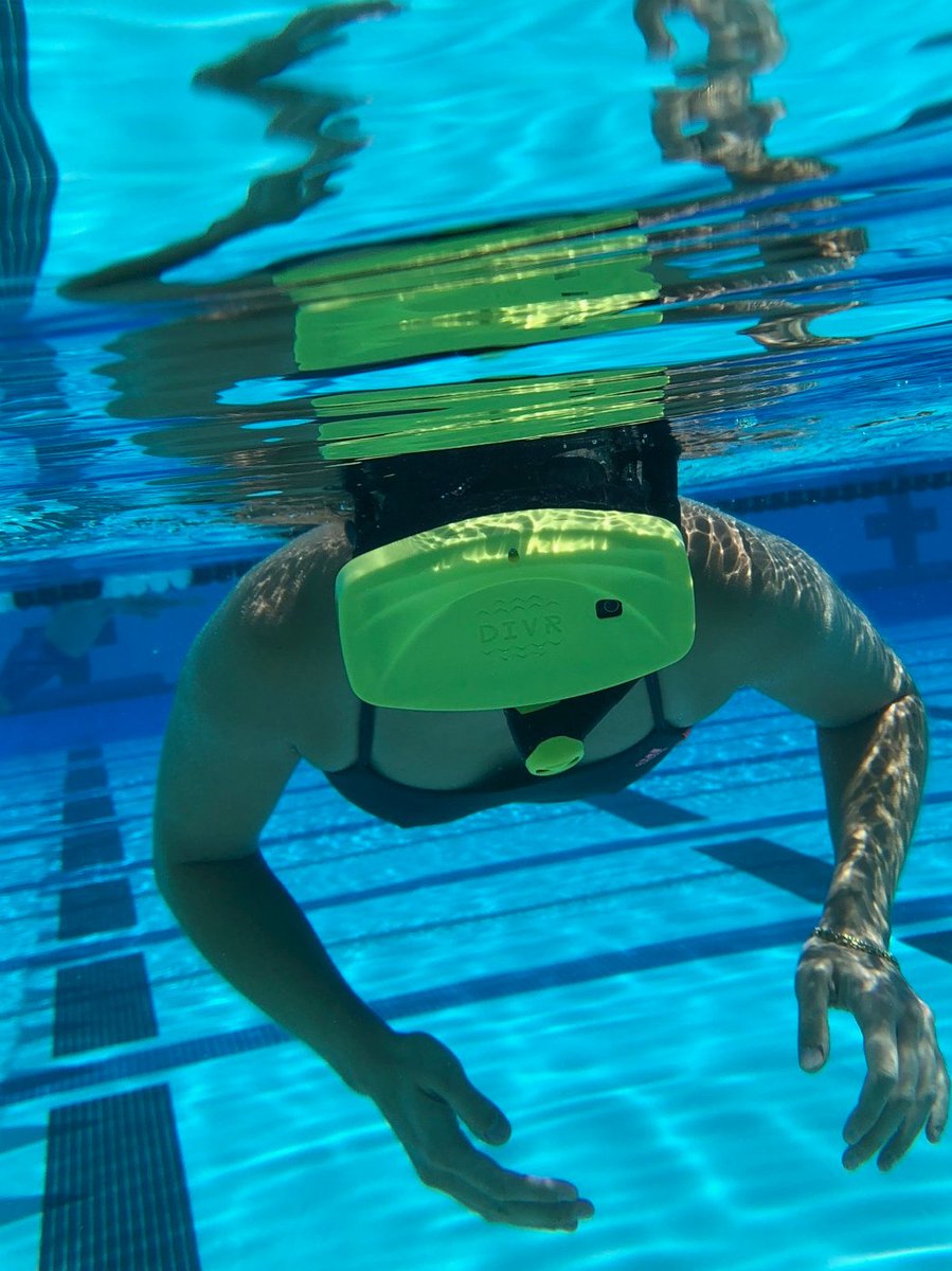 An underwater picture of a paerson in a swimming pool in VR goggles